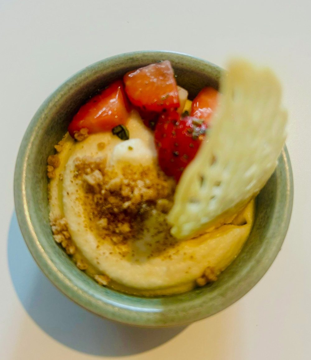 Dessert mit Erdbeeren, Mango-Creme, Krokant und filigranem Tuile-Chip in grüner Steingutschale