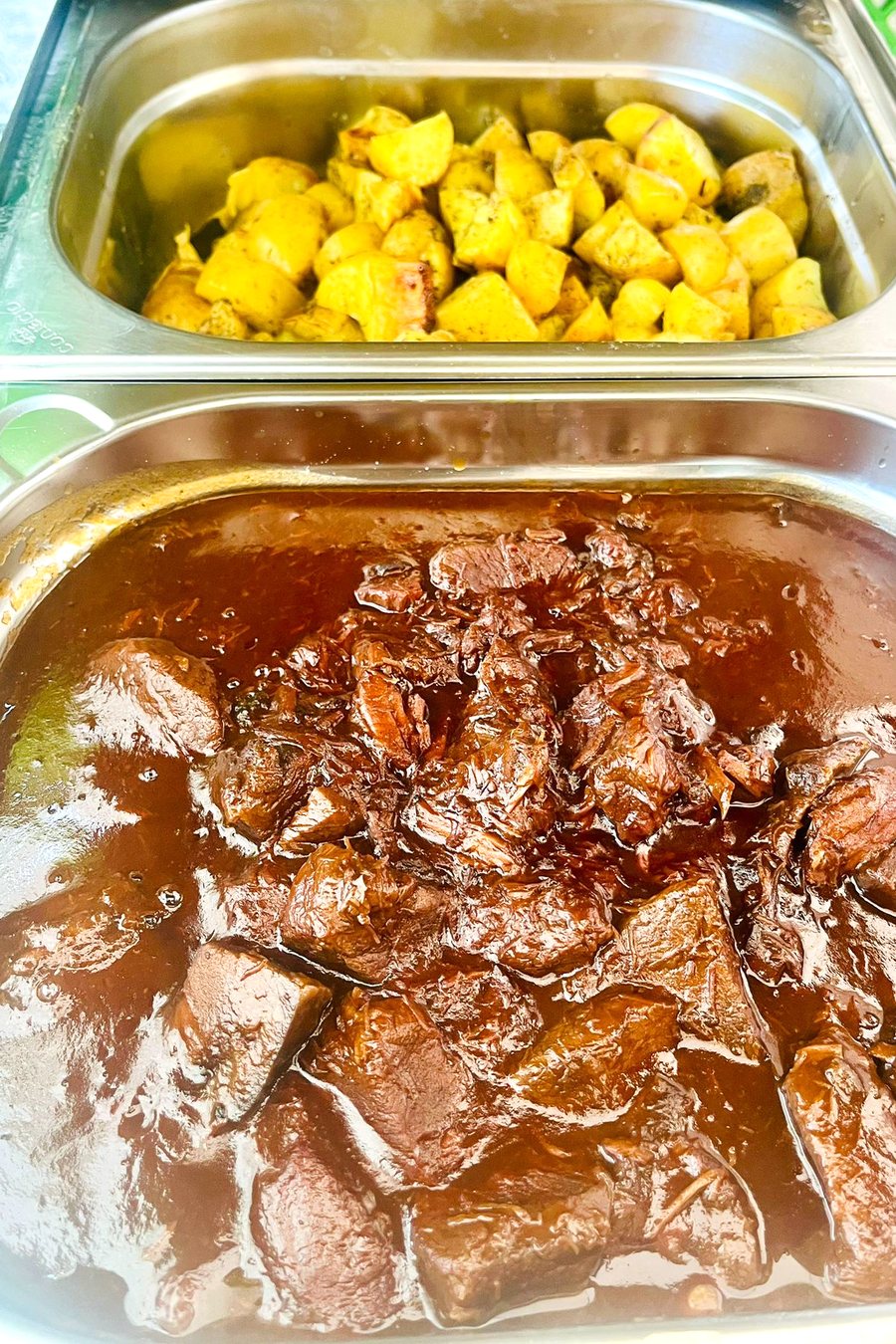 Chafing Dish mit Rindergulasch in dunkler Sauce und Curry-Kartoffeln